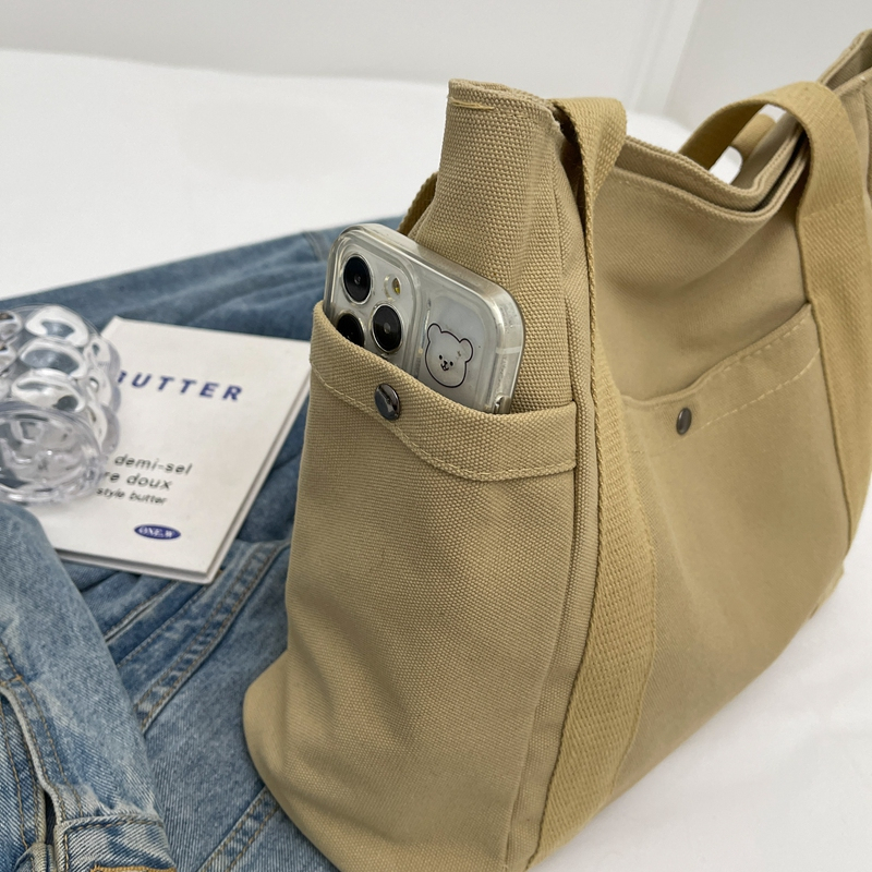 A close-up of the texture of high-quality thick canvas fabric and the precise stitching technique.